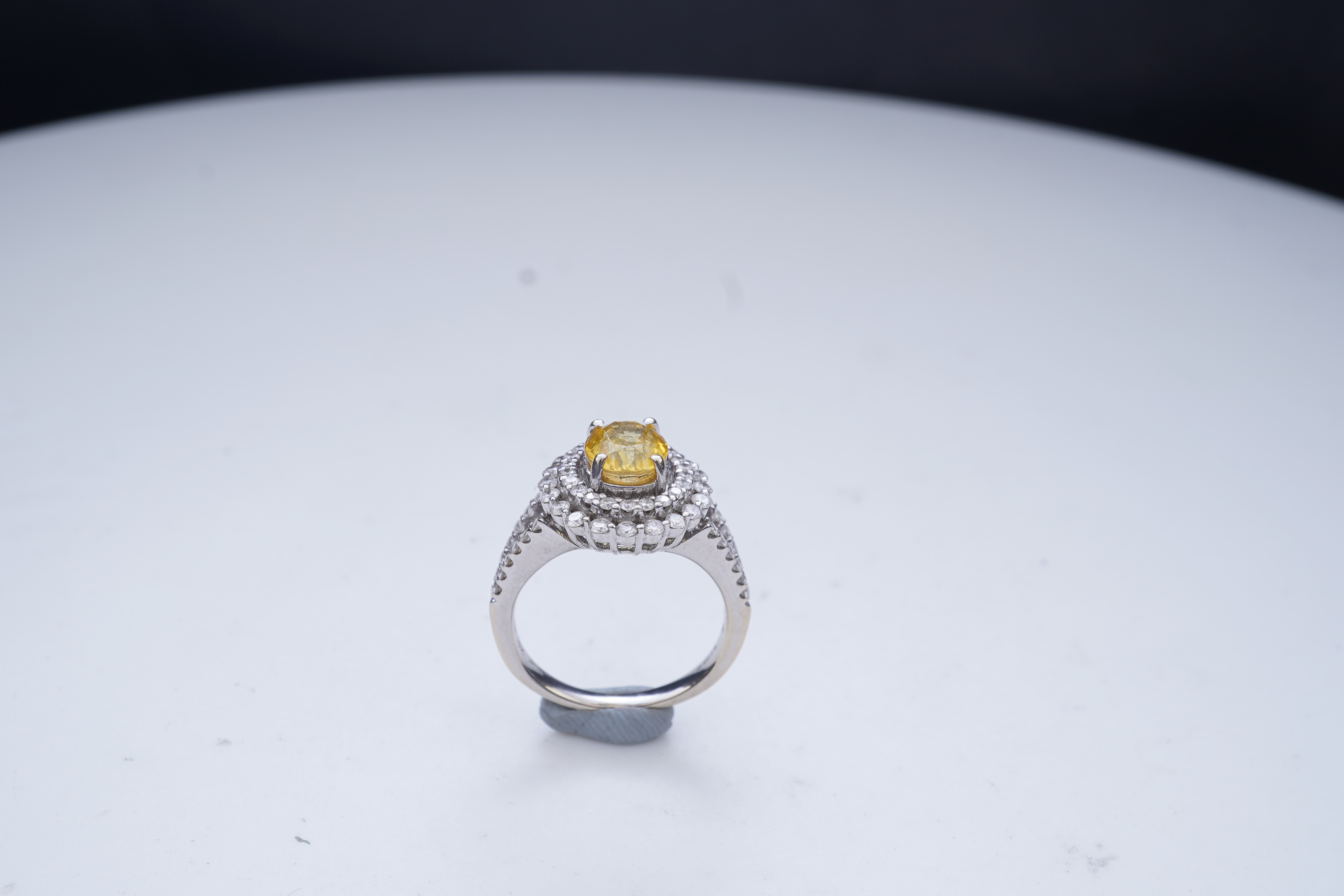 A yellow sapphire and diamond ring